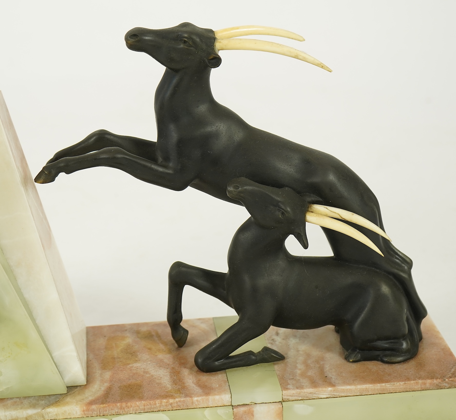Attributed to Uriano (Ugo Cipriani, Italian, 1897-1960), a French green and cream onyx pyramid shaped clock